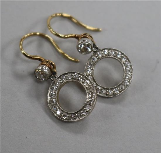 A pair of yellow metal and diamond set drop hoop earrings, overall 15mm.